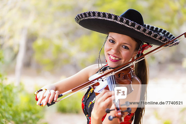 USA  Texas  Young woman playing violin  smiling  portrait