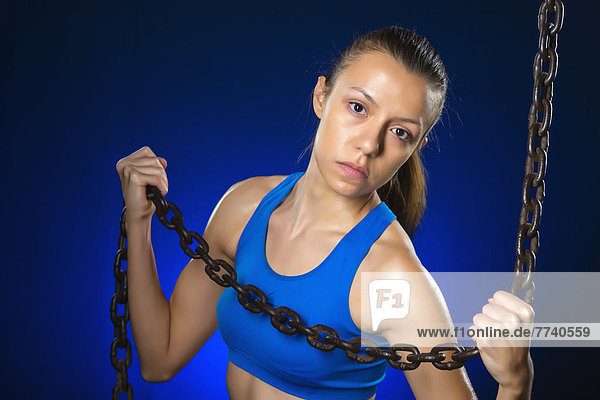 Young woman exercising with chain  close up