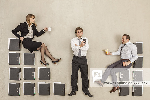 Business people sitting on file stairs in office break