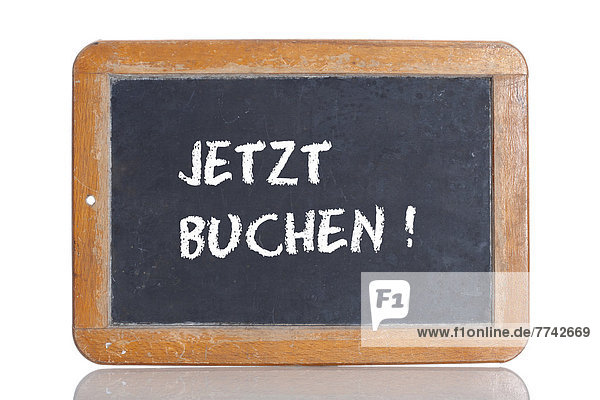 'Alte Schultafel mit Aufschrift ''JETZT BUCHEN!'''