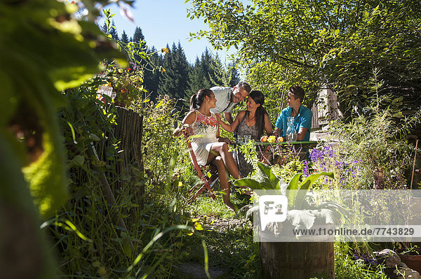 Austria  Salzburg Country  Family having garden party  smiling