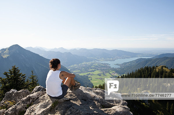 Mid adult woman looking from Bodenschneid to lake Tegernsee