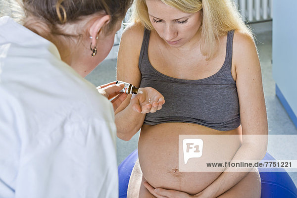 Während der Entbindung bekommt die Schwangere von ihrer Hebamme ein homöopathisches Mittel
