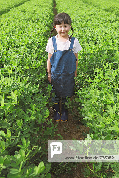 Young girl standing in a vegetable field