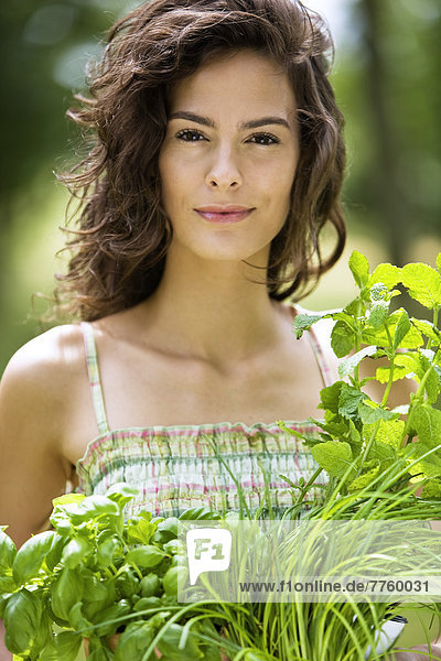 Young woman with aromatic herbs
