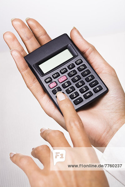 Woman's hands holding a calculator