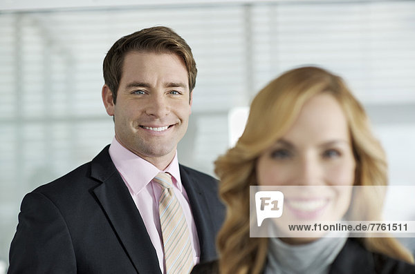 Business couple smiling at camera