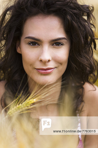 Portrait of young woman in wheat field