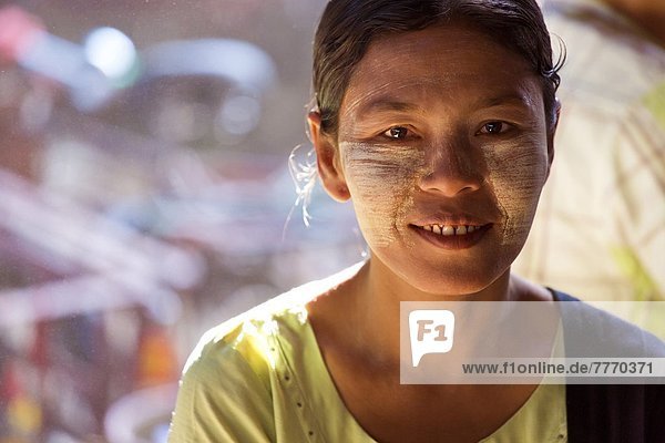 Local woman with Thanakha traditional face painting  Thiri Mingalar Market  Yangon (Rangoon)  Myanmar (Burma)  Asia