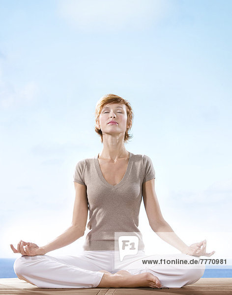 IN*Young woman in yoga position