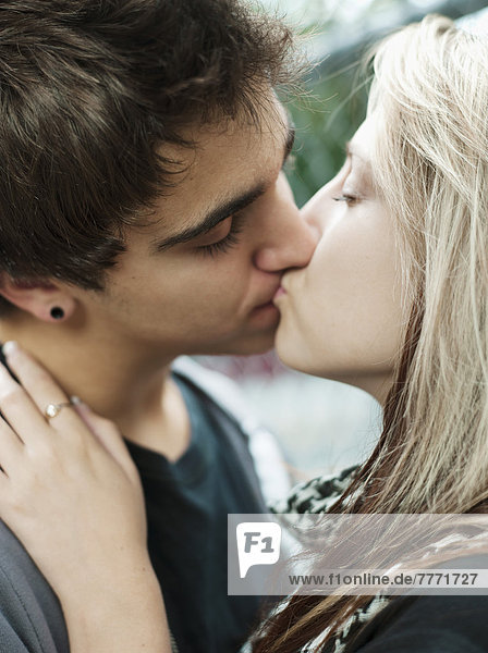 Teenagers kissing