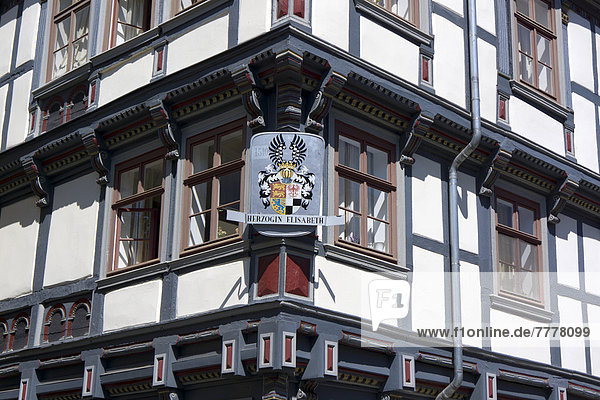 Half-timbered house with a coat of arms