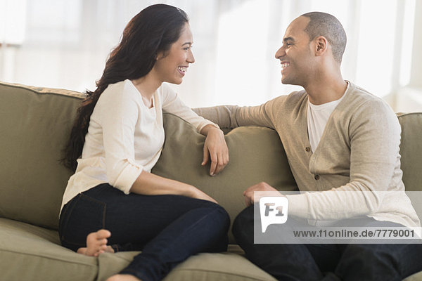 Portrait of young couple sitting on couch