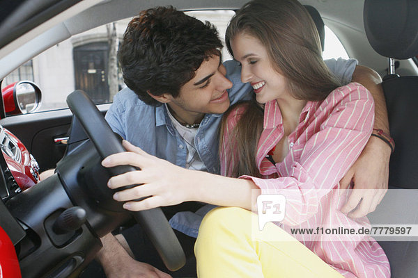 Portrait of couple in car  man embracing woman