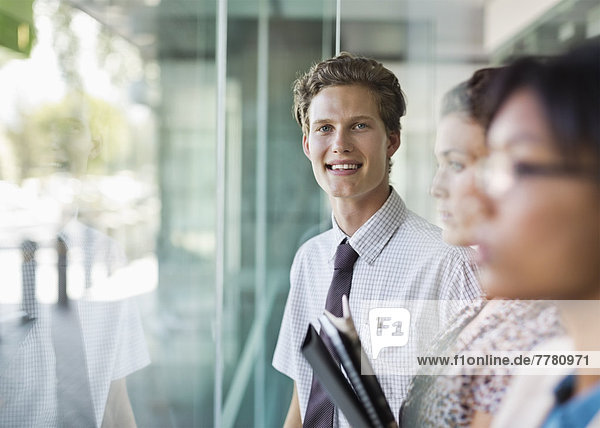 Businessman smiling at office window