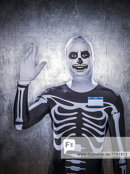 Caucasian man wearing skeleton costume