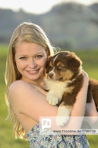 Young woman with australian sheperd puppy  Bavaria  Germany  Europe