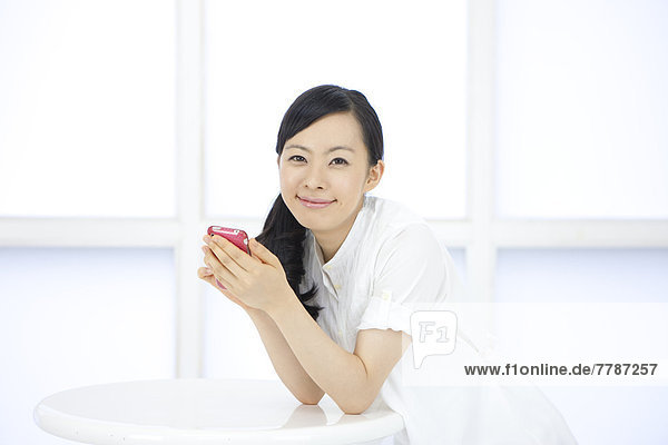 Young woman holding a smart phone