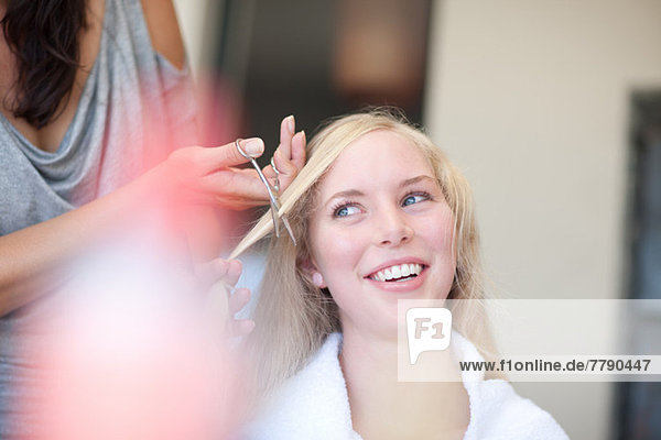 Young woman having haircut
