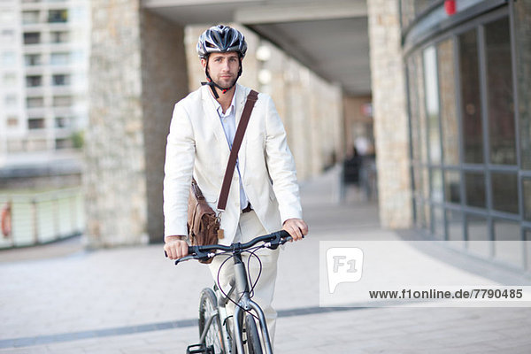 Young man on bicycle wearing helmet