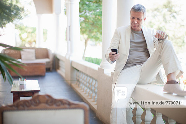 Mature man texting on smartphone