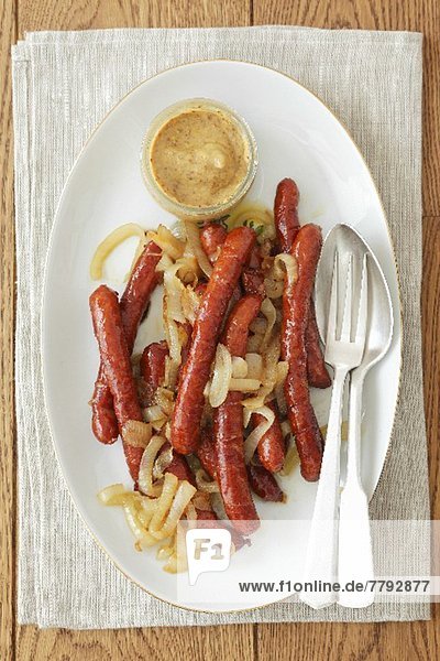 Thin bratwurst sausages with onions and mustard