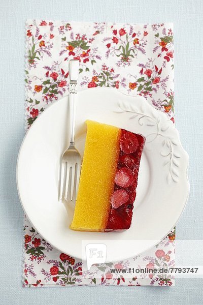 A slice of peach-berry jelly topped with whipped cream