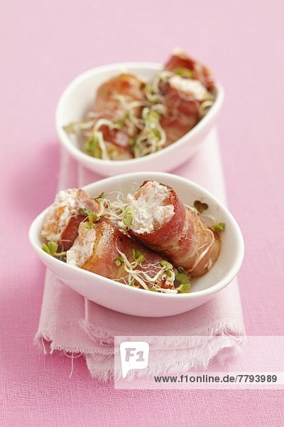 Rolls of smoked bacon filled with smoked salmon mousse