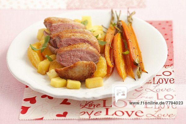Duck breast with pineapple  oranges and baby carrots