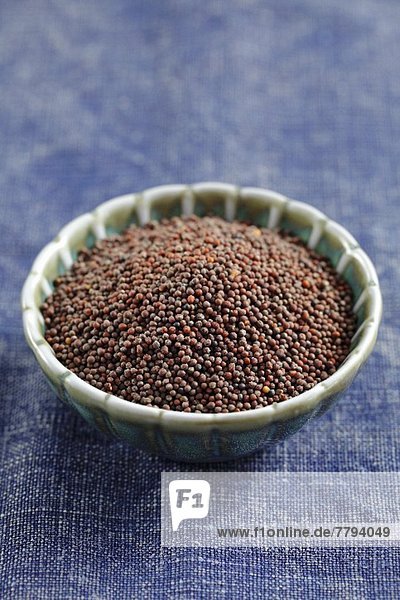 Black mustard seeds in a bowl