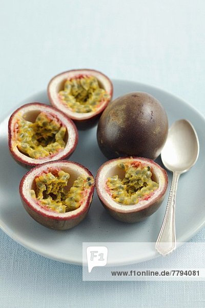 Purple passion fruits  whole and halved