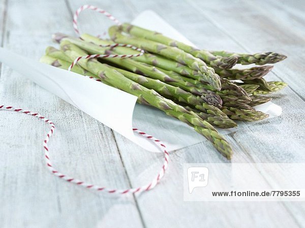 Fresh green asparagus on a piece of paper