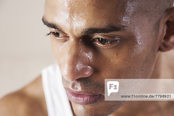 Close-Up Man's Sweating Face in Studio with White Background