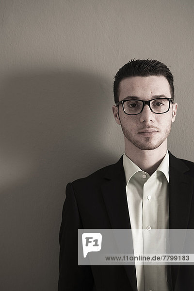 Portrait of Young Man wearing Glasses  Looking at Camera  Studio Shot