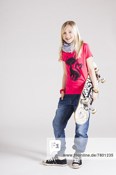 Full Length Portrait of Girl with Skateboard in Studio