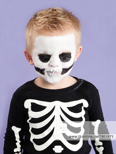 Portrait of boy (2-3) in skeleton costume for Halloween