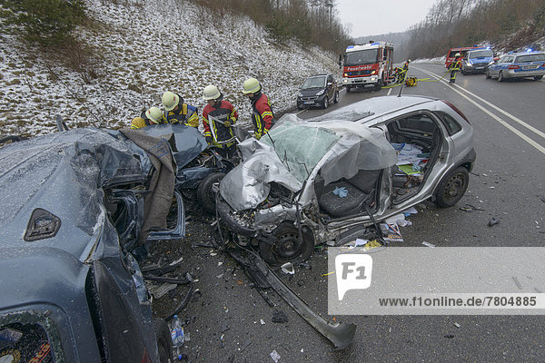 Head-on collision of a Dacia Logan with an Opel Corsa  rescue workers at the accident site