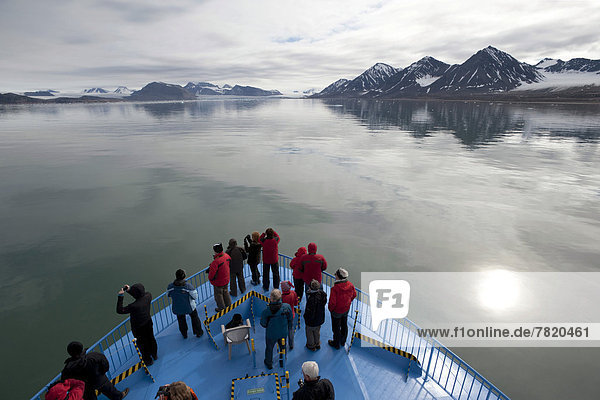 Passengers of the expedition cruise ship  MS Quest  observing the scenery of Kongsfjorden