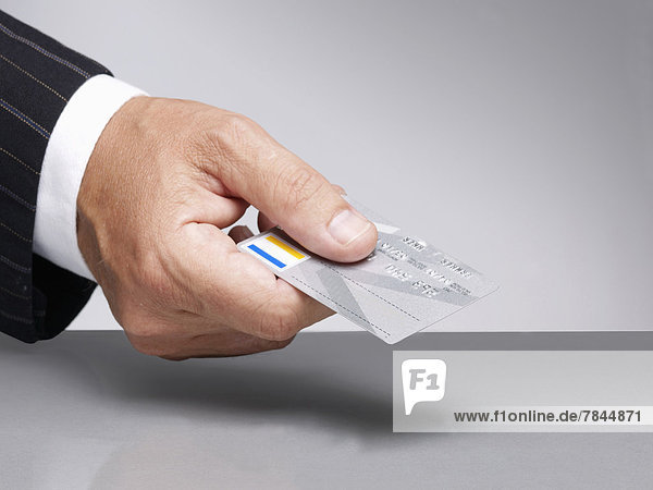 Businessman holding credit card for paying