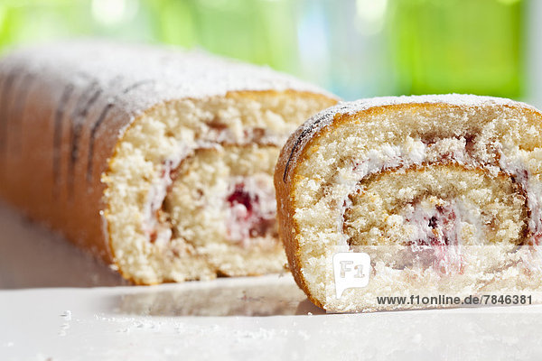 Raspberry roll sponge cake close up