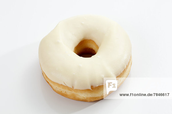 Doughnut topped with icing on white background  close up
