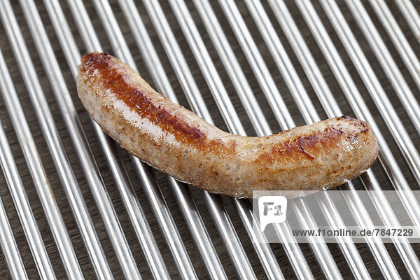Grilled fresh pork sausage on barbecue grill  close up