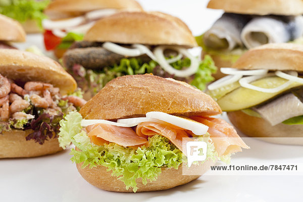 Varieties of bread rolls with fish on white background  close up
