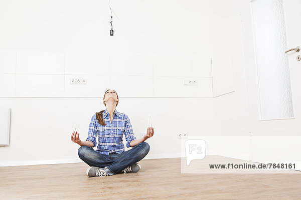Woman sitting on floor with bulbs