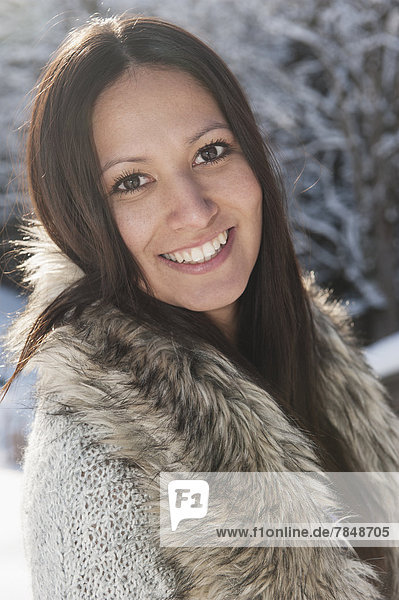 Austria  Salzburg  Portrait of young woman in snow  smiling