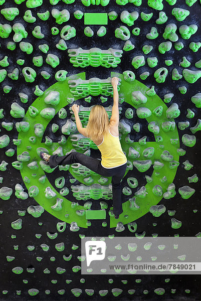Junge Frau beim Bouldern