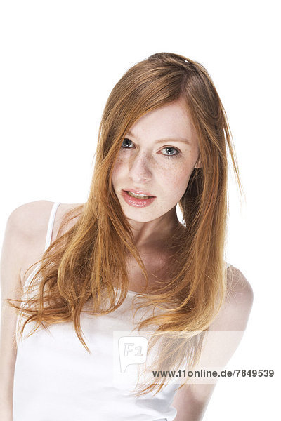 Portrait of young woman against white background  close up