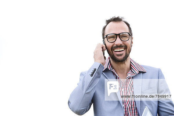 Germany  Bavaria  Businessman talking on mobile phone  smiling