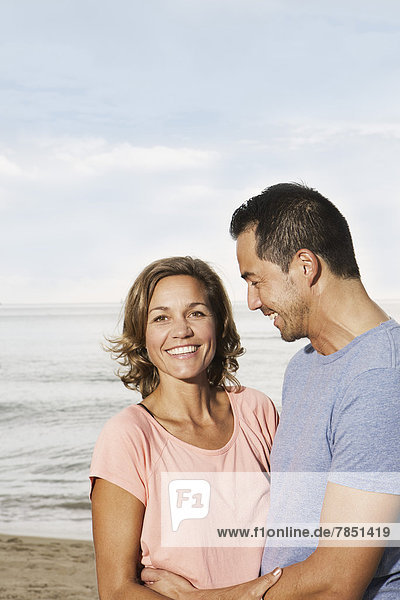 Spain  Mid adult couple on beach at Palma de Mallorca  smiling