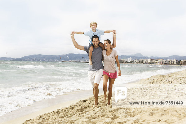 Spain  Family walking on beach at Palma de Mallorca